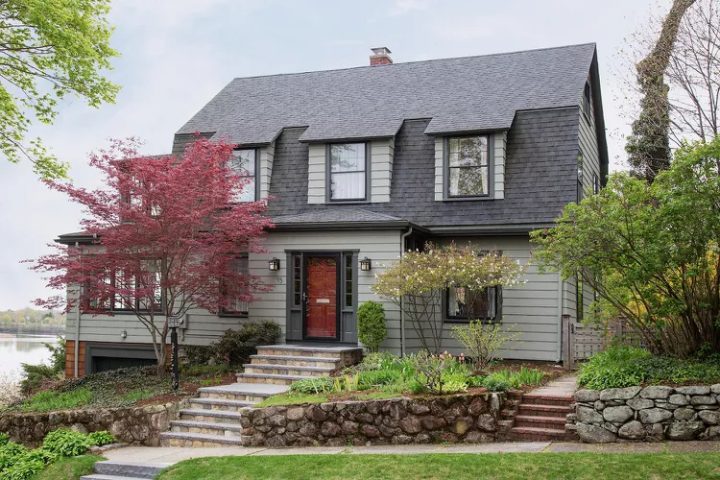 Gambrel-Roof Dutch Colonial Home by Water with Green-Gray Siding