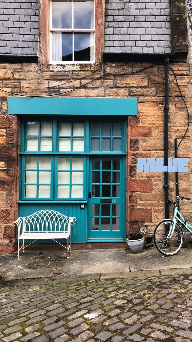 Teal Door at a Cobblestone Storefront