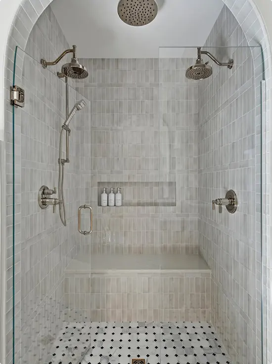 Double Arched Shower with Pale Gray Subway Tile and Dot Floor
