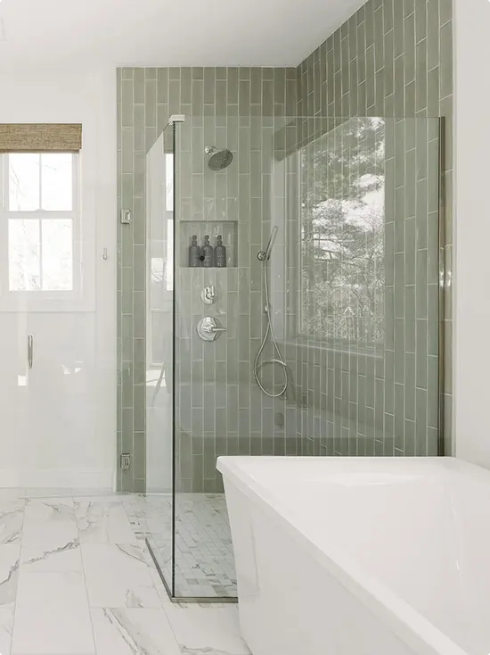 Vertical Sage Green Subway Tile with White Marble Floor and Freestanding Tub