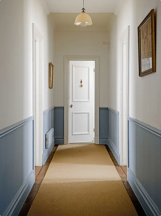 Dusty Blue Hallway with White Wainscoting