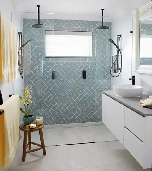 Aqua Herringbone Tile with Ceiling Mounted Showers