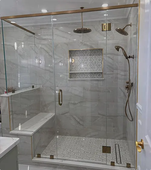 Built-In Bench beside a Gray Marble Shower Wall with Gold Fixture