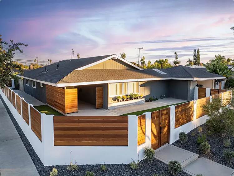 Contemporary Fence with Warm Horizontal Wood Panels Anchored by White Concrete Columns