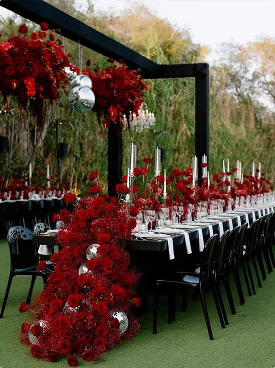 Black Outdoor Dining Table with Red Rose Runner