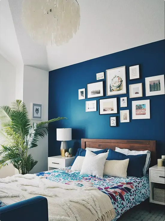 Deep Cobalt Gallery Wall Above a Wood Headboard