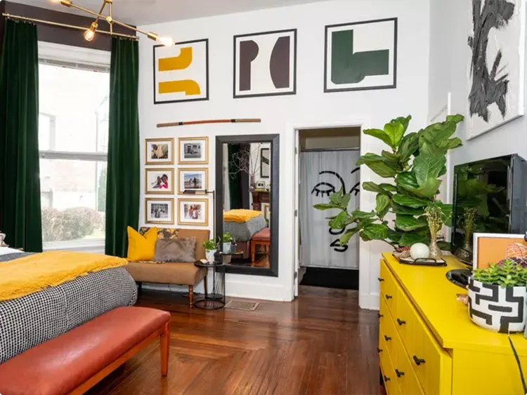 Three Abstract Prints Near a Yellow Dresser