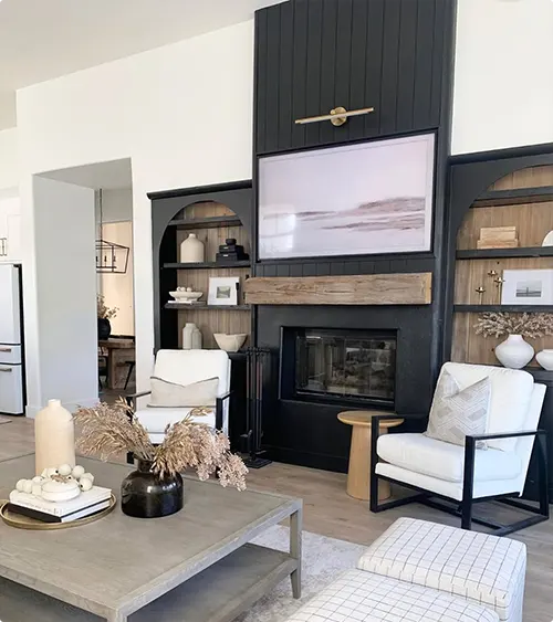 A Black Shiplap Wall Framed by Arched Built Ins with Open Shelving