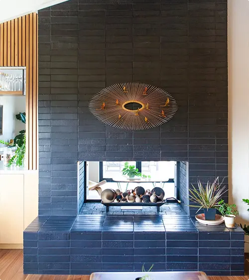 Black tile fireplace with two sides