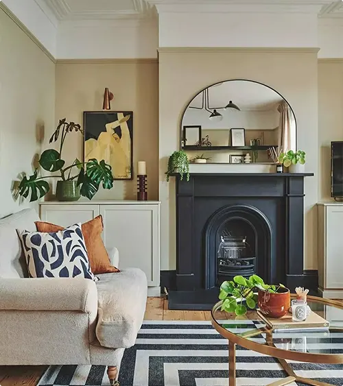 Greenery beside a black traditional fireplace