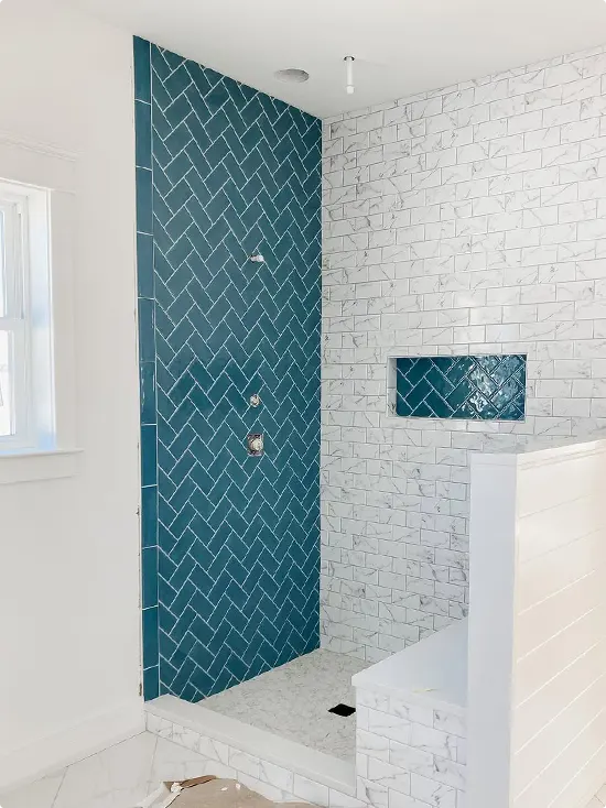 One Accent Wall in Teal Herringbone with White Marble Subway Tile Walls