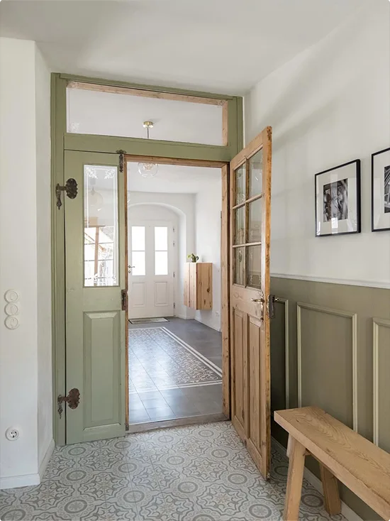 Original Wood Door Entryway with Natural Hardware, Patterned Tile Floor, and Sage Green Board and Batten Wall