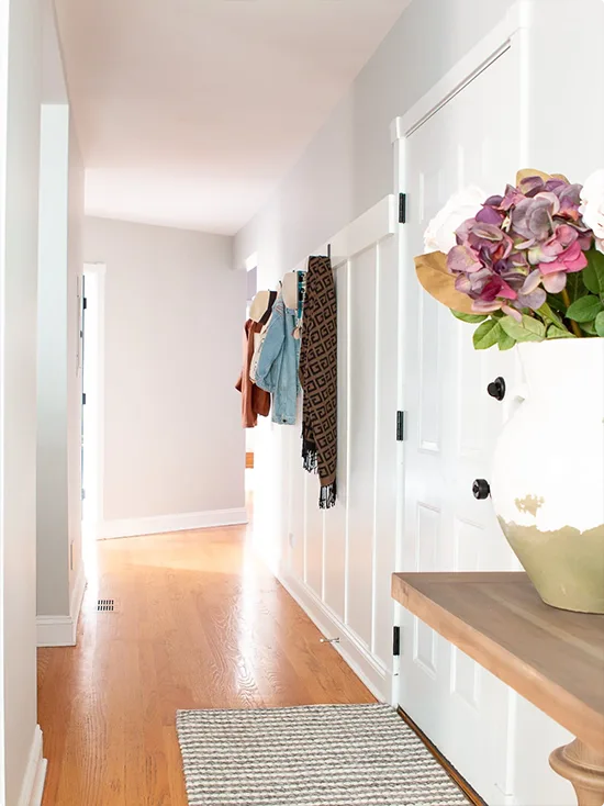 White Hallway Treatment with Black Metal Hooks