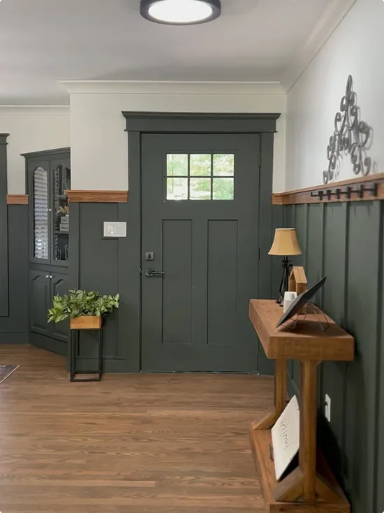 Wood Accents Against a Dark Forest Green Board and Batten Wall