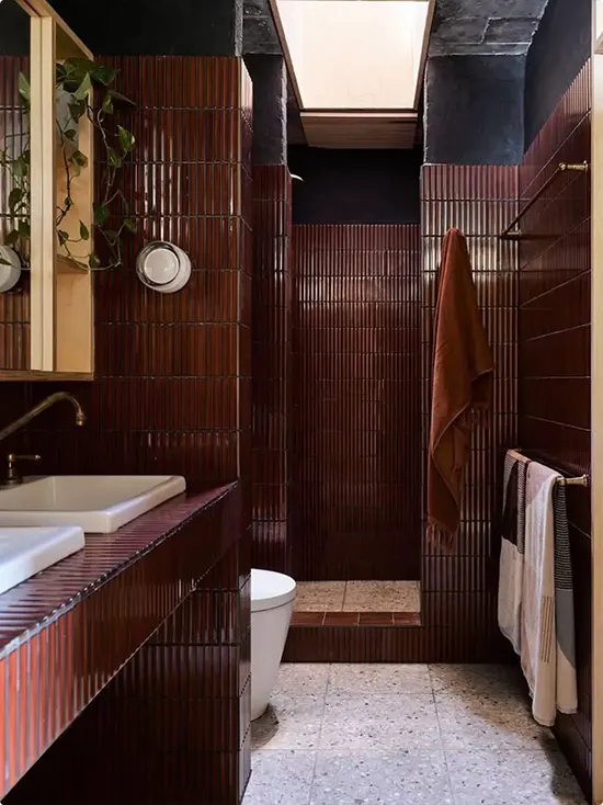 A Bathroom of Terrazzo and Dark Cherry Ribbed Wall Tile