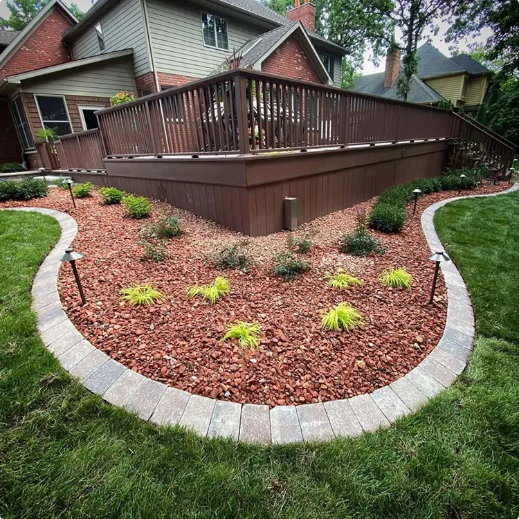 A Mulch Bed of Lava Rock with a Curved Brick Edge
