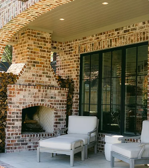 Brick Outdoor Fireplace with an Arched Opening at a Covered Patio