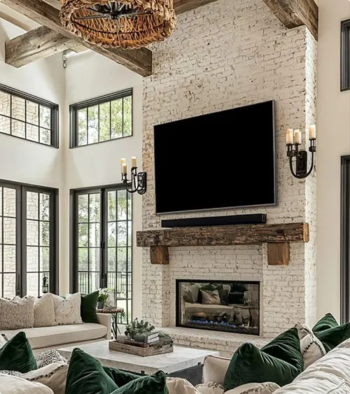 Whitewashed Brick Fireplace Two Stories High with Wood Beams by the Mantel