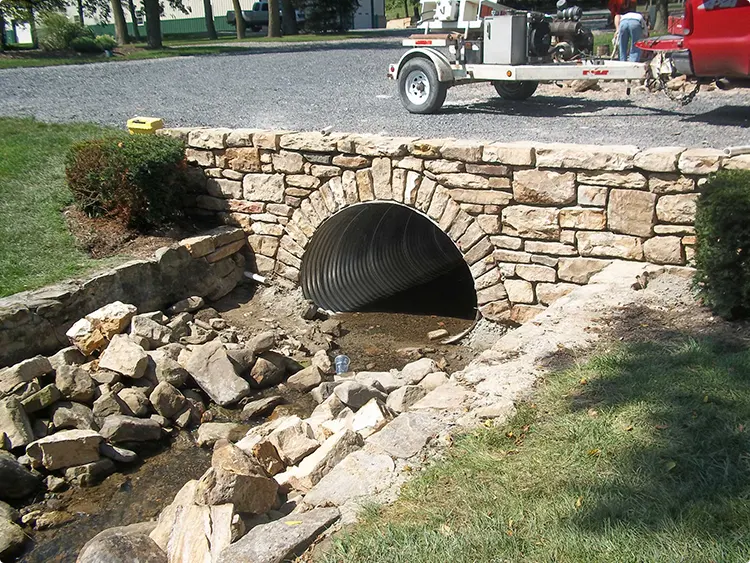 Large Corrugated Metal Culvert with Fieldstone Arch Wall