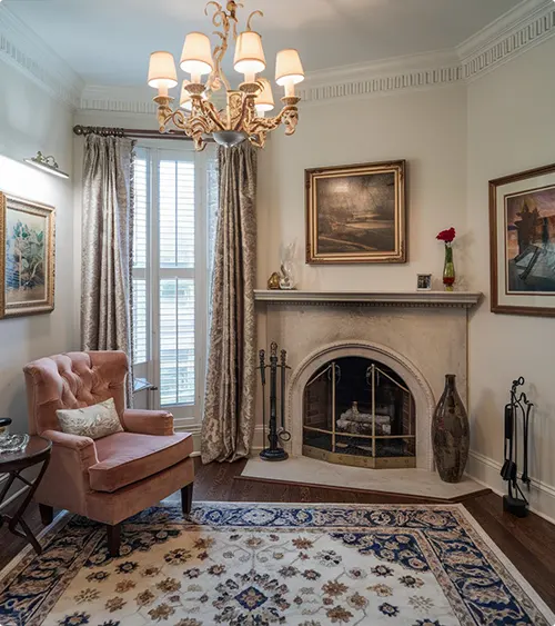 Old-World Corner Fireplace with Creamy Stone Surround
