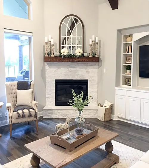 Whitewashed Farmhouse Brick Fireplace with Chunky Mantel and Arched Mirror