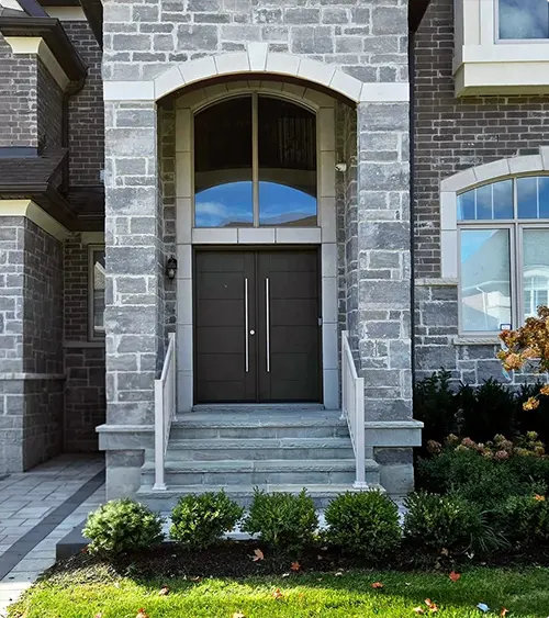 Black Double Doors with a Stone Surround