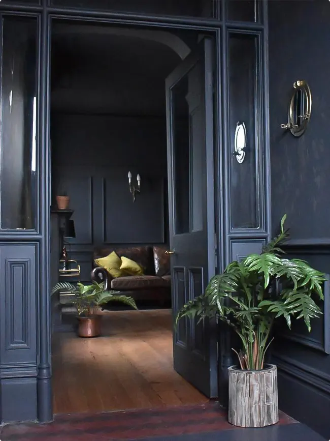 Dark Hallway with Dark Blue Paneling and Leather Chair Seating