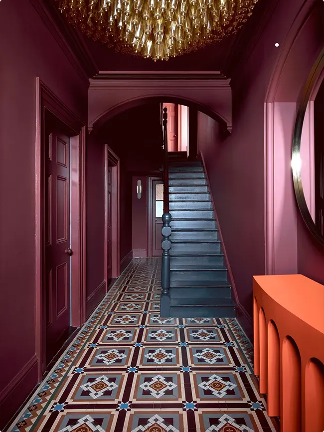 Jewel Tone Hallway with Plum Walls and Teal Stairs