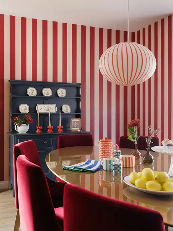 Red and Cream Striped Walls with Velvet Chairs
