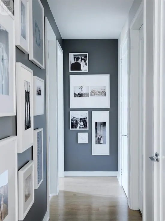 Black and White Photo Gallery in a White Frame Against a Deep Slate Blue Accent Wall