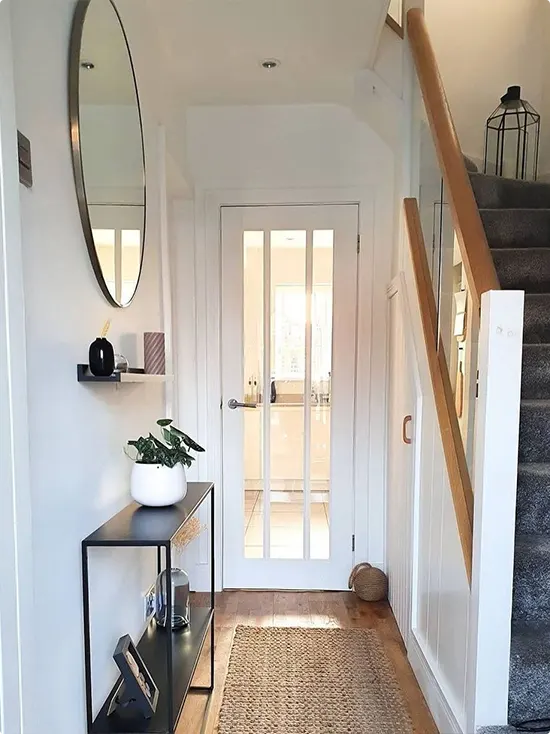 Round Mirror Over a Black Console