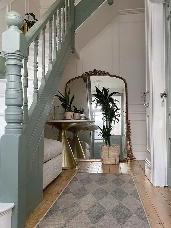 Sage Staircase and Gold Console With Leaning Mirror