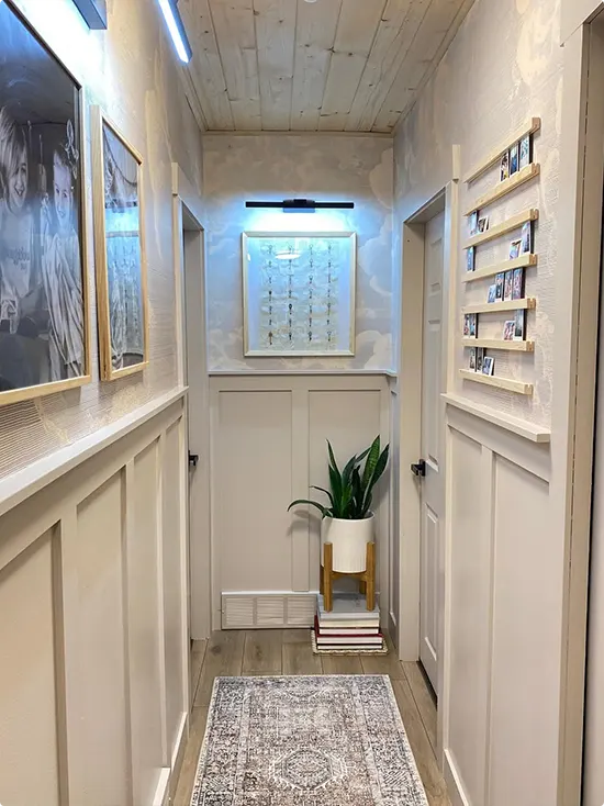 Wainscoted Hallway With Illuminated Art