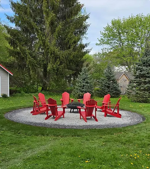 Gray Gravel Fire Pit Seating With Bright Red Chairs