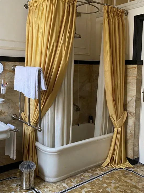 Gold Satin Curtains Around a Classic Clawfoot Tub