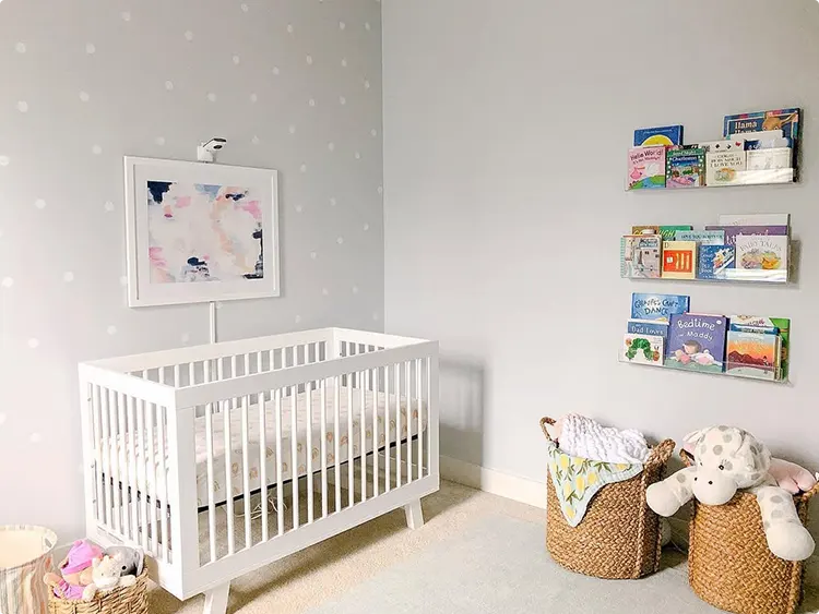 Book ledges and polka dot wallpaper for a nursery wall