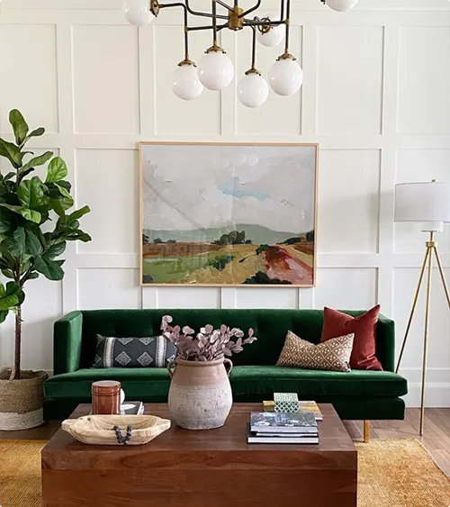 Emerald Couch with White Paneling and Landscape Art
