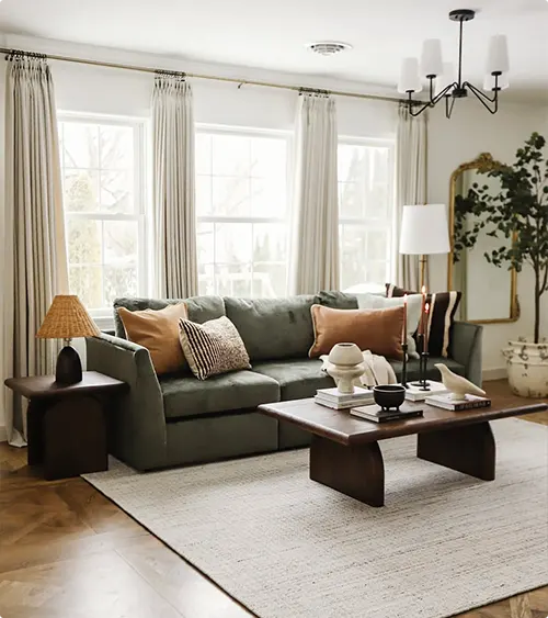 Green Sectional with Warm Neutrals and an Arched Mirror