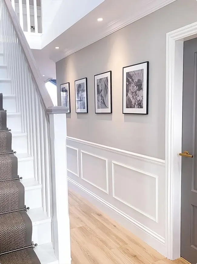 Soft Gray Walls with White Paneling and Matching Black Art