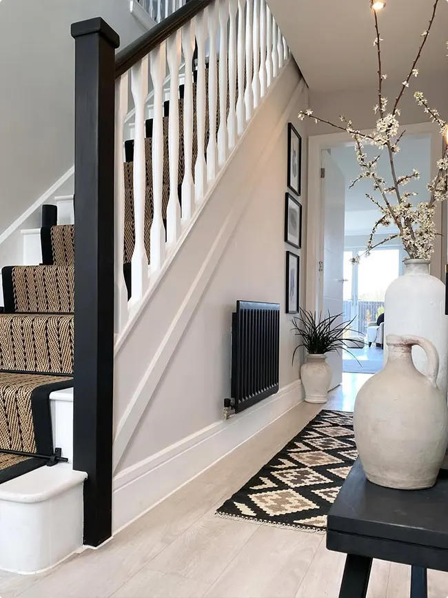 Black patterned runner on a newel post
