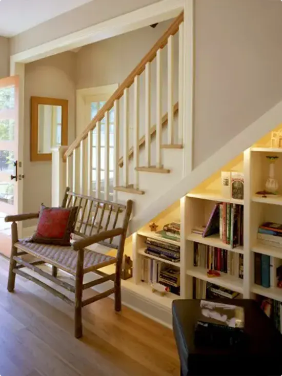 Bench beside bookshelves that follow the steps