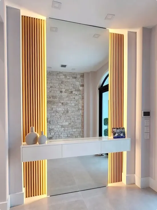 Modern Mirror Between Backlit Wood Slat Panels