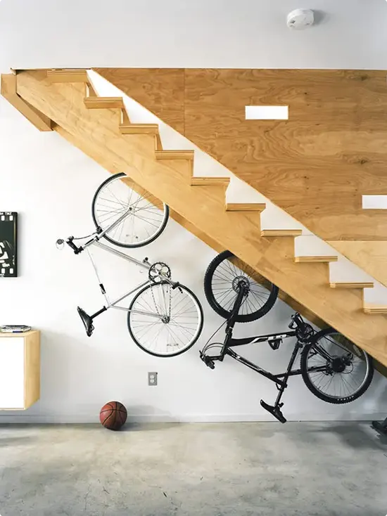 Wall Bike Storage Beneath a Wood Staircase