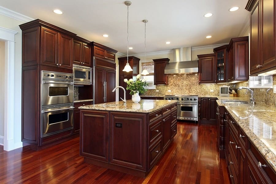 large wood kitchen with granite countertops and island