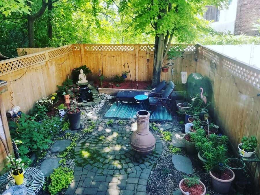 backyard-zen-garden-ideas-beaumondeoriginals secluded backyard with paver patio sun lounges potted plants