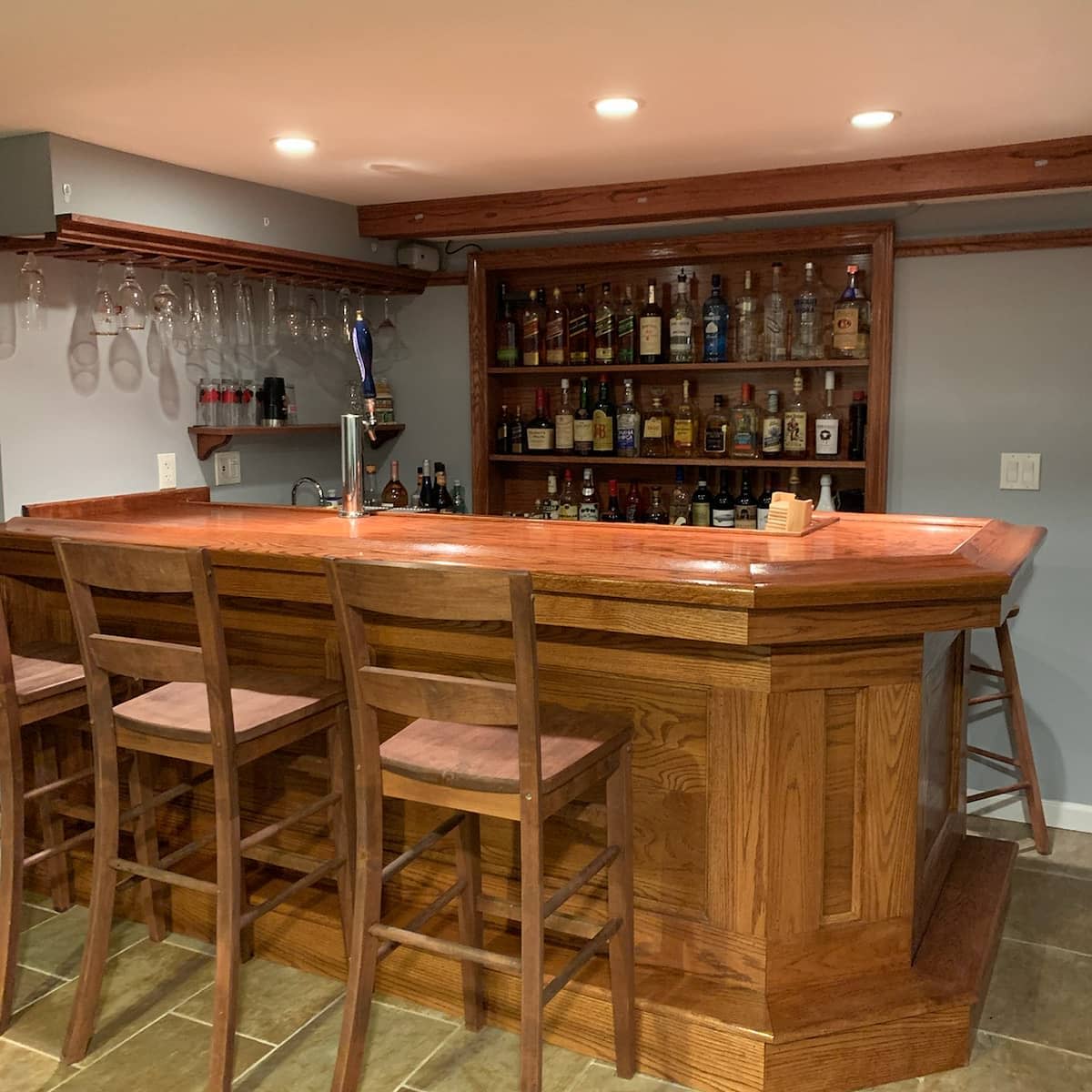 bars20basement20apartment20ideas20-billsbars Traditional wooden basement bar with stools, liquor shelves, and hanging glassware.
