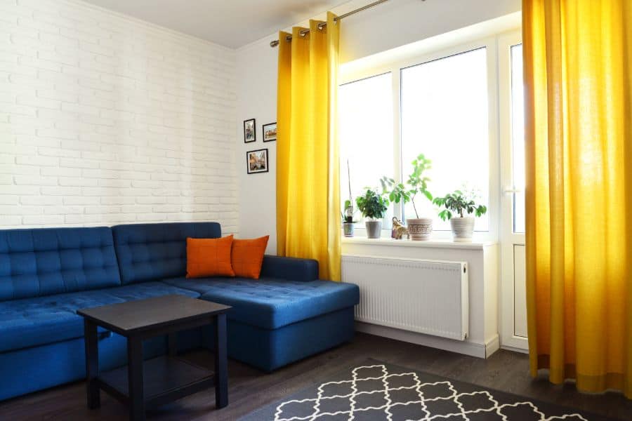 yellow curtains and blue sofa living room