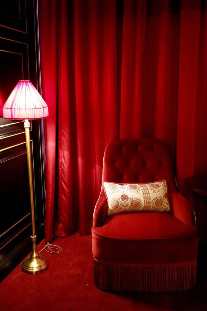 red velvet curtains and accent chair