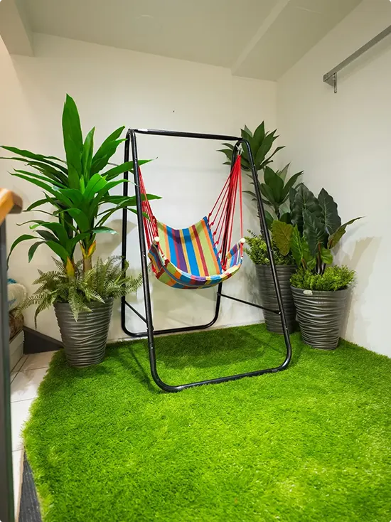 Bright Striped Hammock Chair in an Indoor Green Corner
