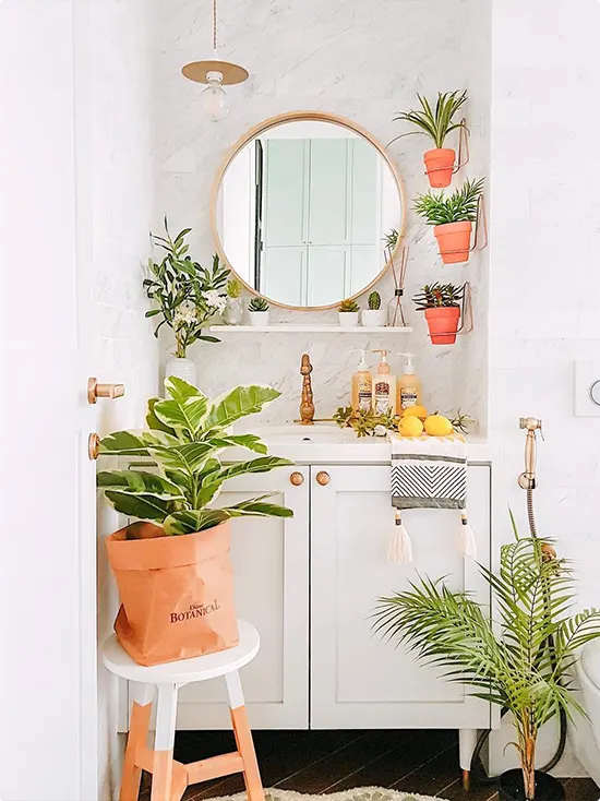 Bright Vanity Bathroom with Round Mirror and Small Wall-Mounted Terracotta Pot